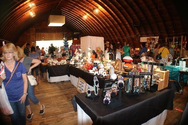 Indoor craft fair vendors inside the barn at Lake Latonka Fall Festival
